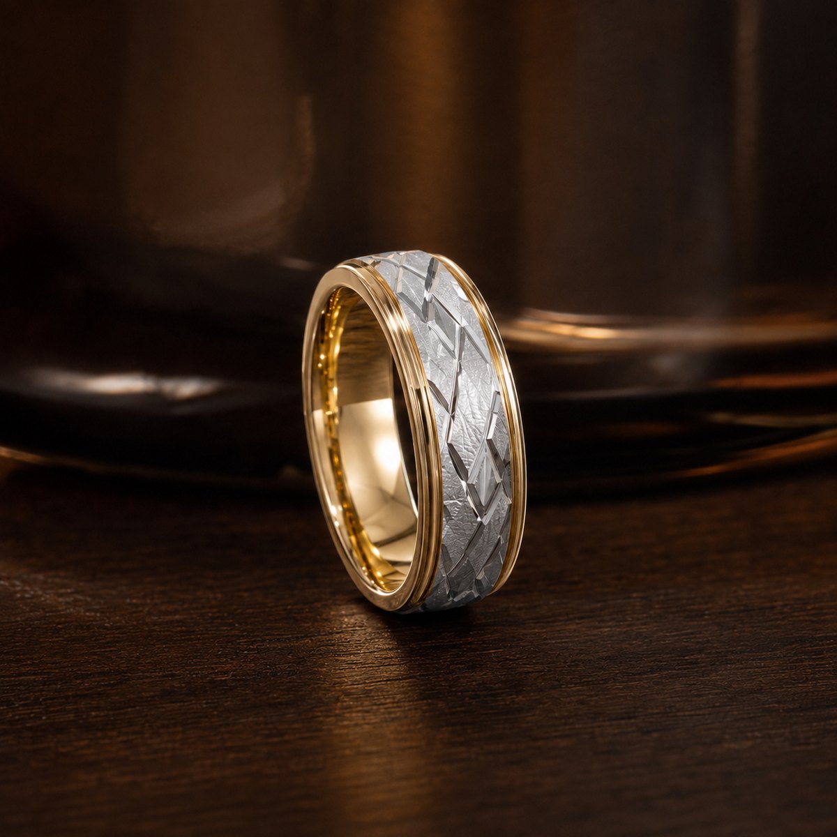 The Solstice: a two-tone yellow and white gold diamond-cut wedding band, photographed on stone