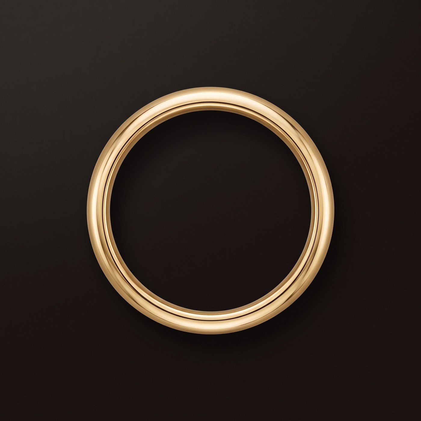 A solid gold wedding band photographed from directly above